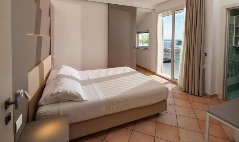 Camera da letto moderna con terrazza e bagno.